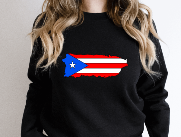 woman wearing a black crewneck sweatshirt with the puerto rican flag in the shape of the island of puerto rico.