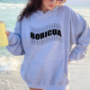Woman wearing a gray hoodie with the word Boricua echoed written in a wavy font in black
