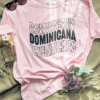 Pink T-shirt with the word "Dominicana" written in a wavy font across the chest in the color black.