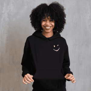 woman wearing a black hoodie with a winking face on upper left side