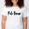 Woman wearing a white t-shirt with the phrase "Pelo Bueno" written across the front in black.