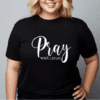 Woman wearing a black t-shirt with the phrase "Pray Wait Trust" written across the chest in white.