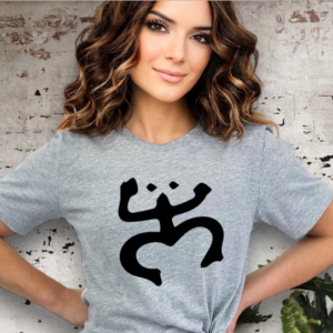 Woman wearing a gray t-shirt with a Taino Coqui on the chest in black.