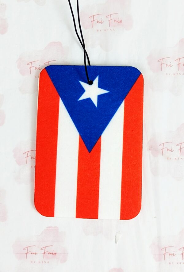 Car air freshener with the design of the Puerto Rican flag vertically. Black stretchy string to hang from rearview mirror.