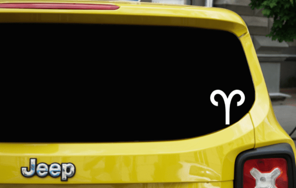 Yellow SUV with the Aries zodiac sign in the bottom right hand part of the back window.