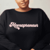Black crewneck sweatshirt with the word "Mamapreneur" across the front in pink.
