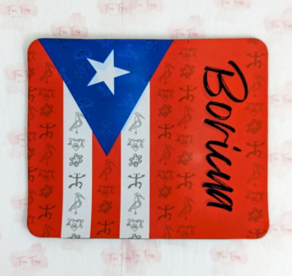 Mouse pad with the Puerto Rican Flag. The right side of the flag has a larger red size with the word "Boricua" written on it. There are Taino Petroglyphs over the entire mouse pad.