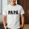 Older man with white t-shirt with the word "Papa" written on the front in black. The last A in Papa has an accent over it as it is the Latino way of pronouncing it.