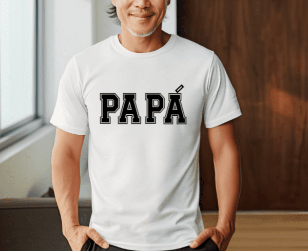 Older man with white t-shirt with the word "Papa" written on the front in black. The last A in Papa has an accent over it as it is the Latino way of pronouncing it.