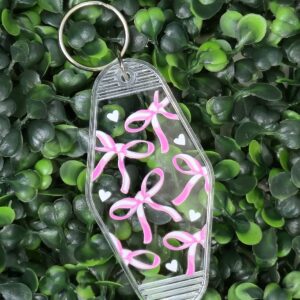 Clear Motel-style keychain with pink bows and white hearts
