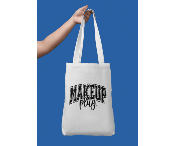 DTF print that says "Makeup Plug" on a white canvas tote bag