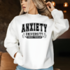 Woman with a white crewneck sweatshirt that reads "Anxiety University Honors Program"