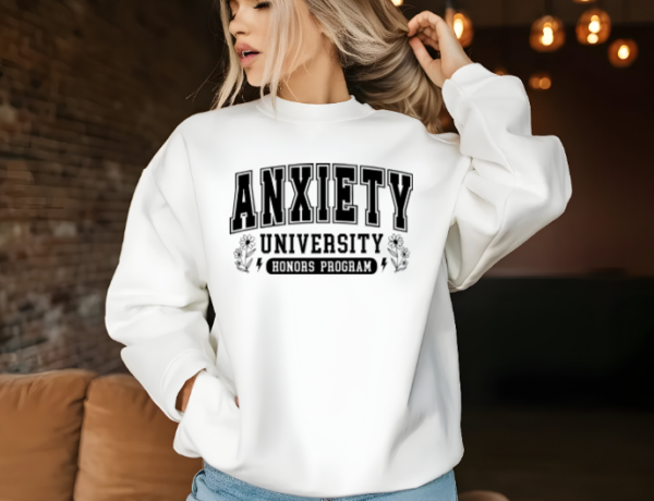 Woman with a white crewneck sweatshirt that reads "Anxiety University Honors Program"